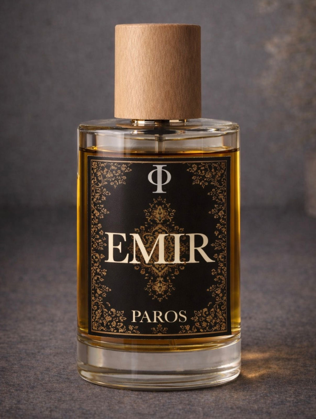 Perfume bottle labeled 'EMIR PAROS' with a dark label and wooden cap on a gray background